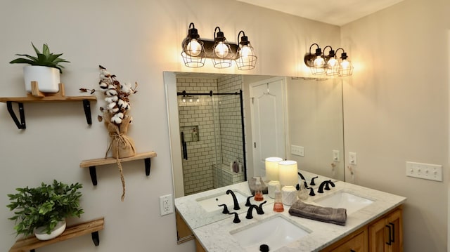 bathroom featuring a shower with door and vanity