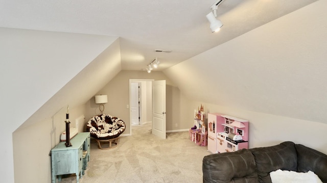 additional living space with light colored carpet and lofted ceiling