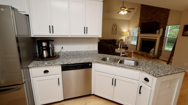 kitchen with white cabinets, appliances with stainless steel finishes, and sink