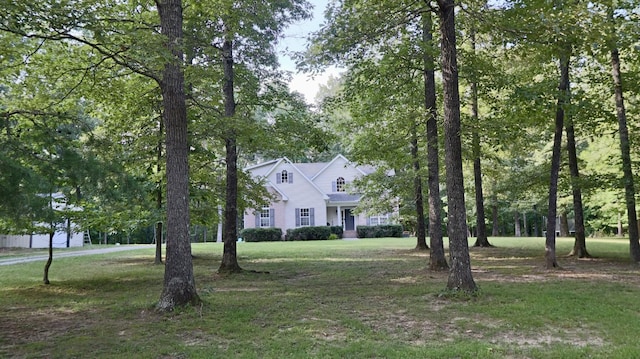 colonial-style house with a front lawn