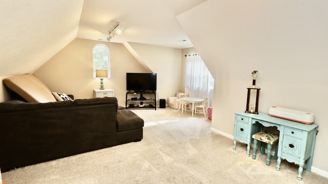 carpeted living room featuring track lighting and lofted ceiling