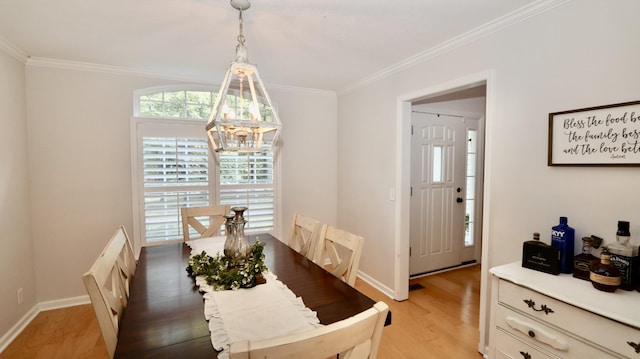 dining area with ornamental molding and hardwood / wood-style flooring