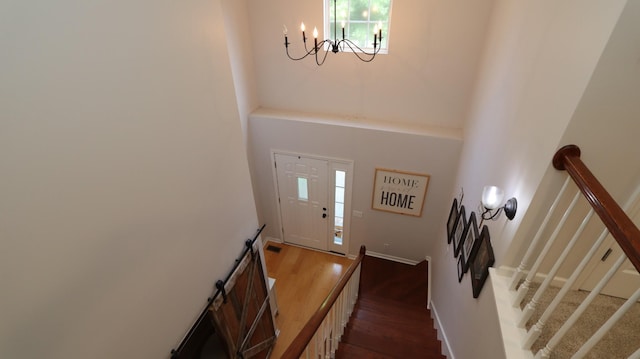 foyer entrance with dark hardwood / wood-style flooring and an inviting chandelier