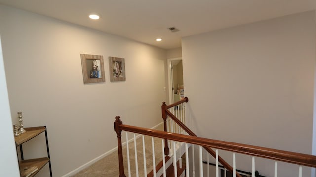 stairway featuring carpet