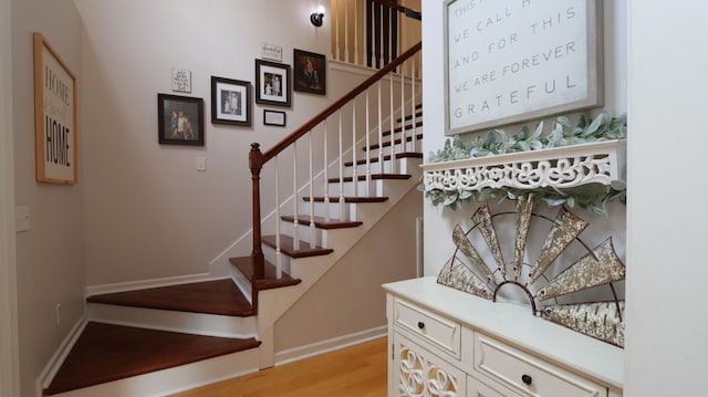 staircase with hardwood / wood-style floors