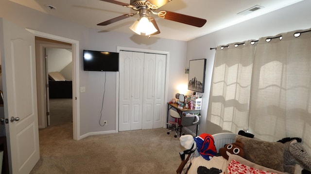 carpeted bedroom with ceiling fan and a closet