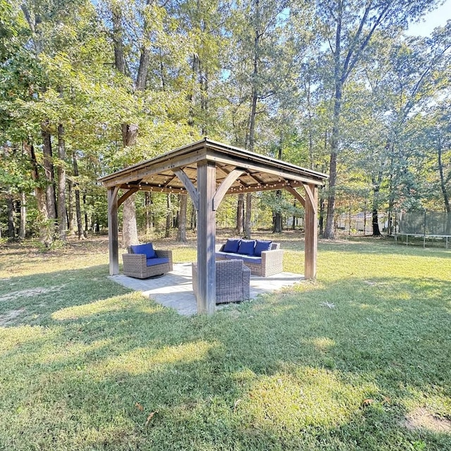 surrounding community with a gazebo, an outdoor hangout area, a trampoline, and a lawn