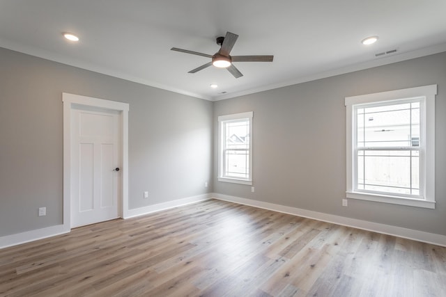 unfurnished room featuring light wood-type flooring, ceiling fan, and crown molding