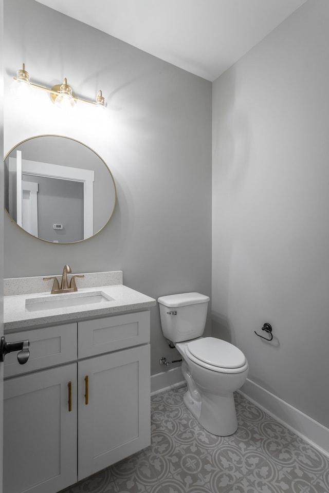 bathroom featuring vanity, toilet, and tile patterned flooring