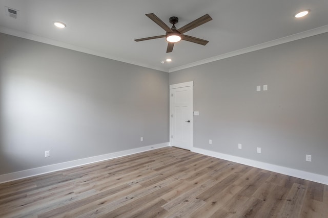 spare room featuring light hardwood / wood-style floors, ceiling fan, and ornamental molding