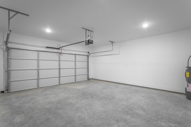 garage with a garage door opener and electric water heater