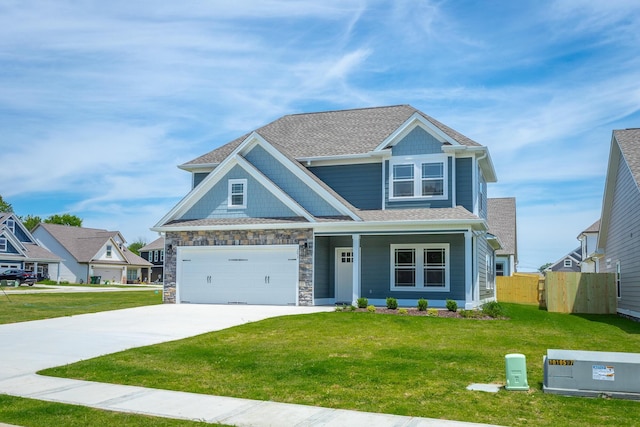 craftsman-style home featuring a front yard and a garage