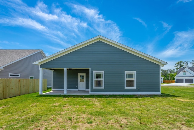 back of house featuring a patio and a yard