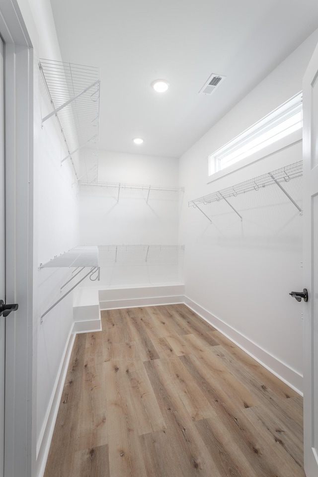 walk in closet featuring light hardwood / wood-style flooring