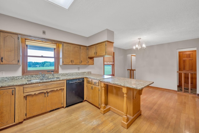 kitchen featuring dishwasher, sink, light wood-type flooring, a notable chandelier, and kitchen peninsula