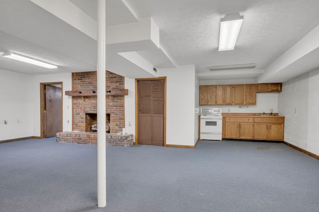 kitchen with carpet, stove, a brick fireplace, a textured ceiling, and sink