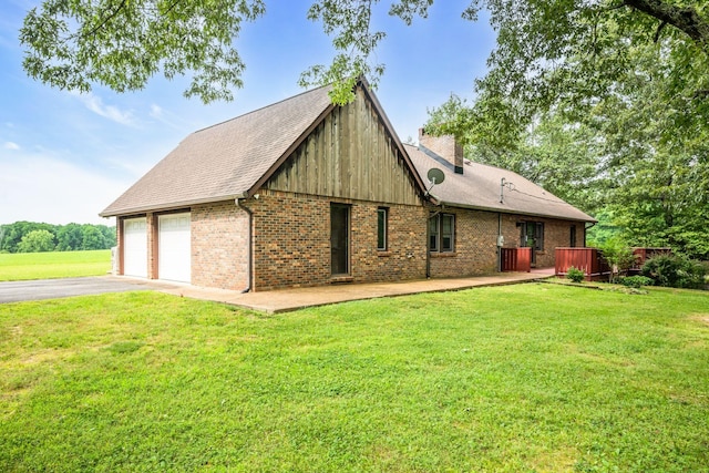 exterior space with a yard and a garage