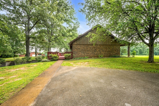 exterior space featuring a lawn and a wooden deck