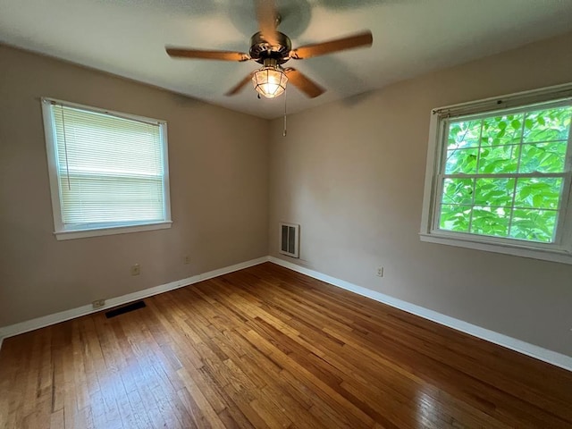 empty room featuring hardwood / wood-style flooring and ceiling fan