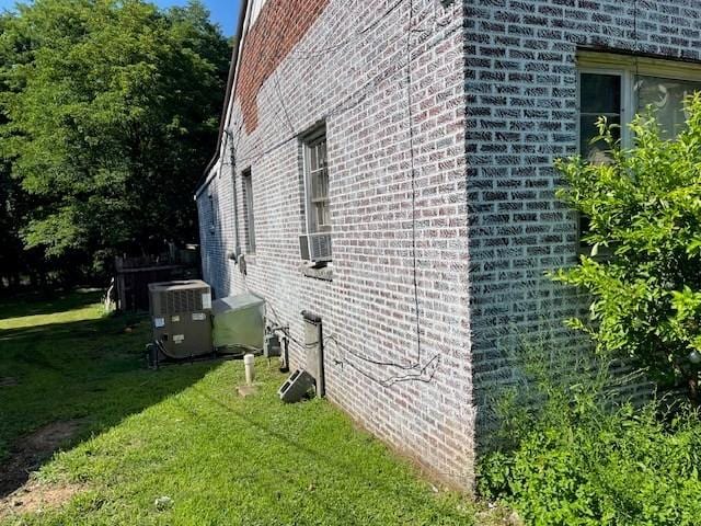 view of property exterior featuring cooling unit and a lawn