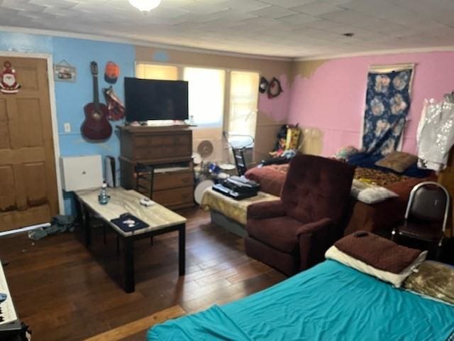 bedroom featuring crown molding and dark wood-type flooring