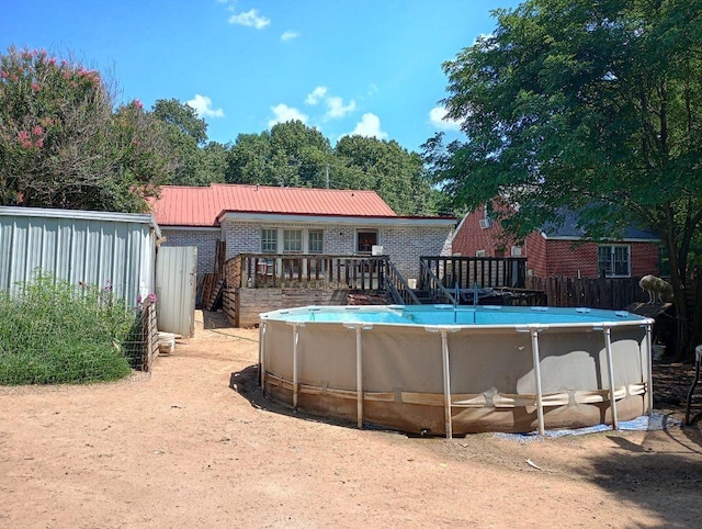 view of swimming pool featuring a wooden deck