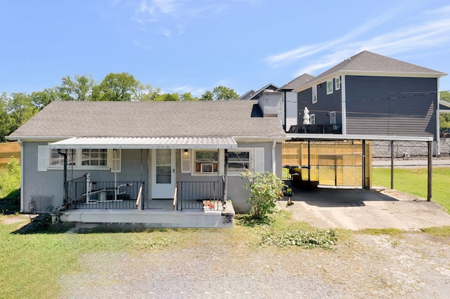 back of house with covered porch and a yard