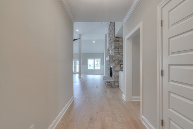 corridor featuring light wood-type flooring and crown molding