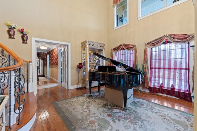 interior space featuring hardwood / wood-style flooring, a high ceiling, and a wealth of natural light