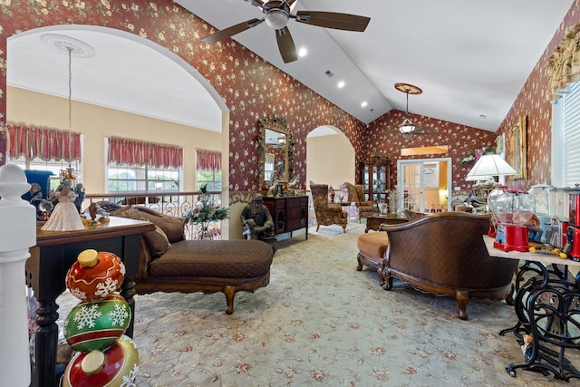 living room featuring ceiling fan, carpet floors, and vaulted ceiling