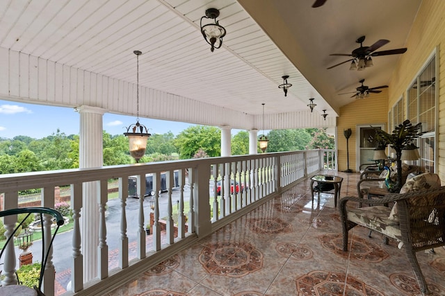 view of patio with ceiling fan and a balcony