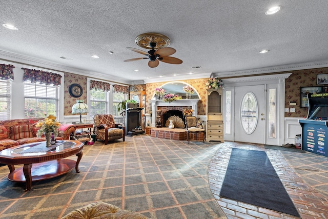 living room with recessed lighting, ornamental molding, a ceiling fan, and wallpapered walls