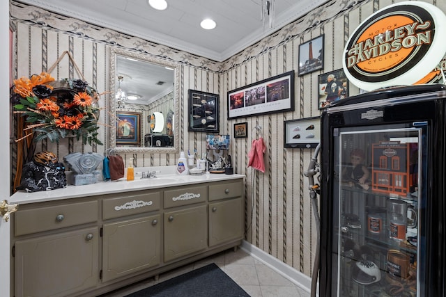 bathroom featuring tile patterned flooring, ornamental molding, and vanity