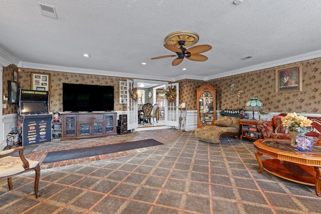 carpeted living room with crown molding, ceiling fan, and a textured ceiling