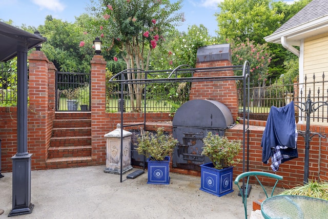 view of patio with a fireplace