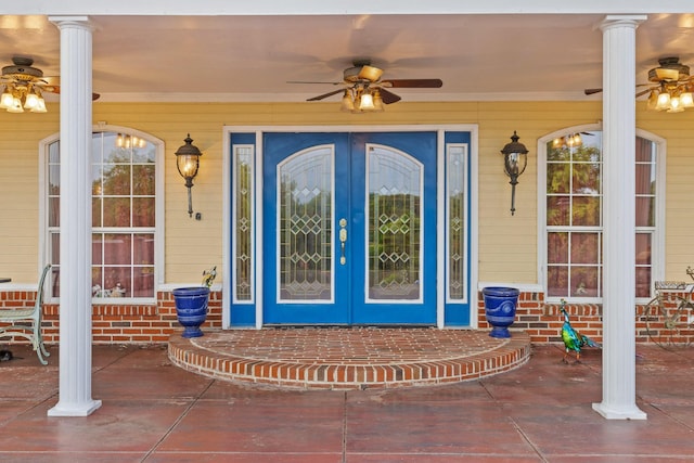property entrance with covered porch, ceiling fan, and french doors