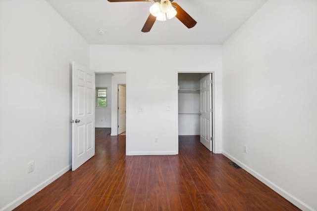 unfurnished bedroom with dark wood-type flooring, a closet, and ceiling fan