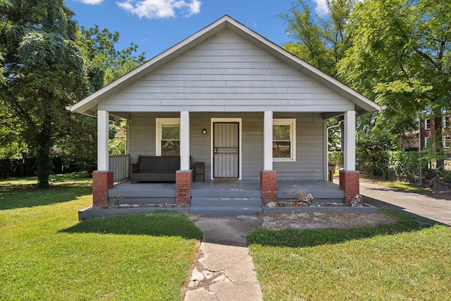 bungalow-style house with covered porch and a front yard