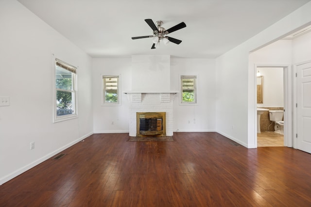 unfurnished living room with wood-type flooring, ceiling fan, and a fireplace