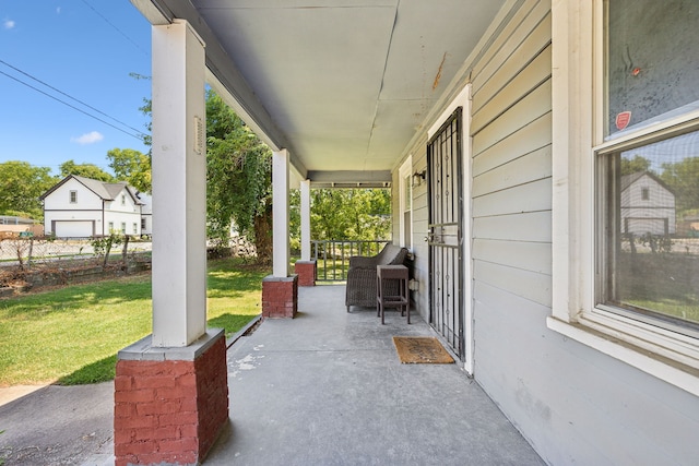 view of patio / terrace featuring covered porch and a garage