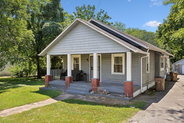 bungalow-style house featuring a front lawn and a porch