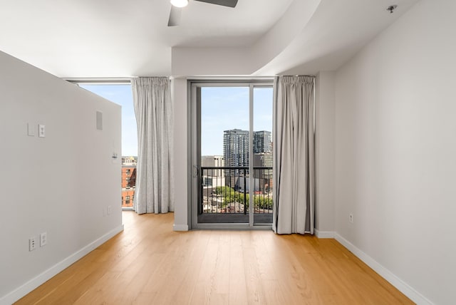 empty room featuring light hardwood / wood-style flooring and ceiling fan