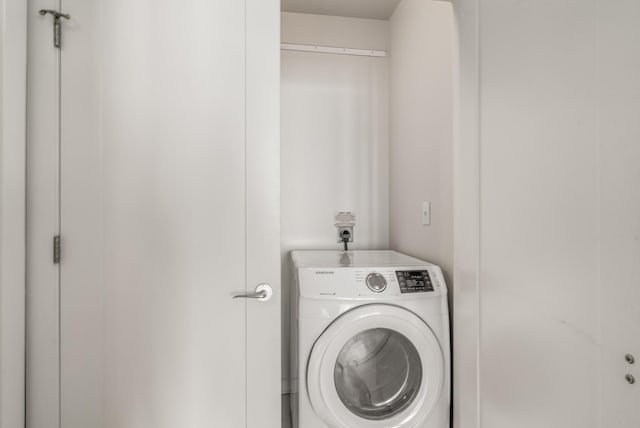 washroom with washer / dryer