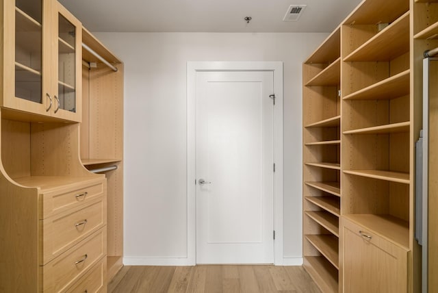 walk in closet featuring light hardwood / wood-style flooring