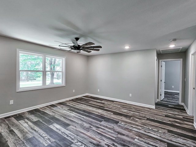 unfurnished room featuring dark wood-type flooring and ceiling fan