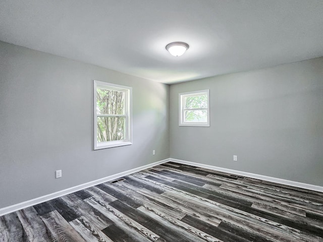 unfurnished room with dark hardwood / wood-style floors