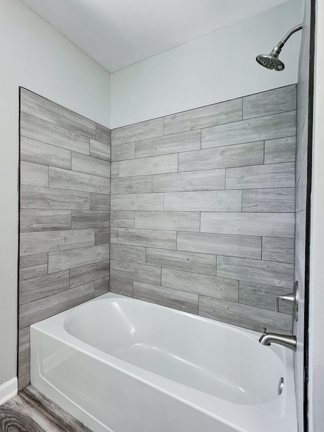 bathroom featuring shower / washtub combination and hardwood / wood-style floors