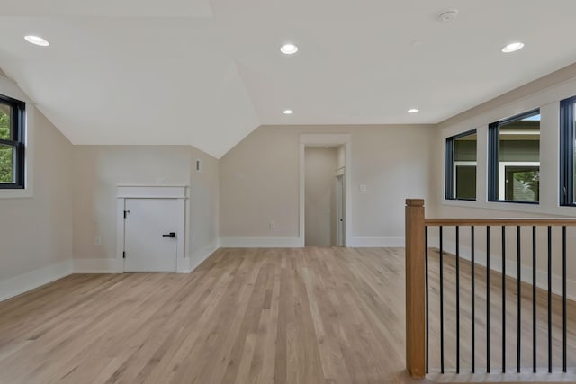 bonus room featuring light hardwood / wood-style floors, lofted ceiling, and a wealth of natural light