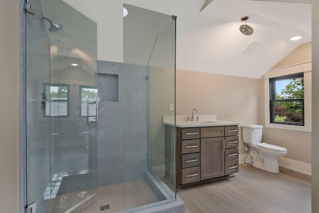 bathroom featuring an enclosed shower, vanity, toilet, and vaulted ceiling