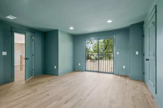 spare room with light hardwood / wood-style flooring